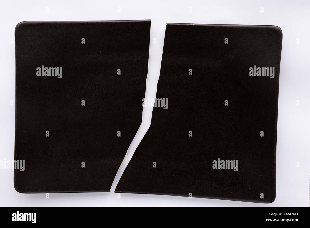 Cracked black ceramic plate Stock Photo Alamy
