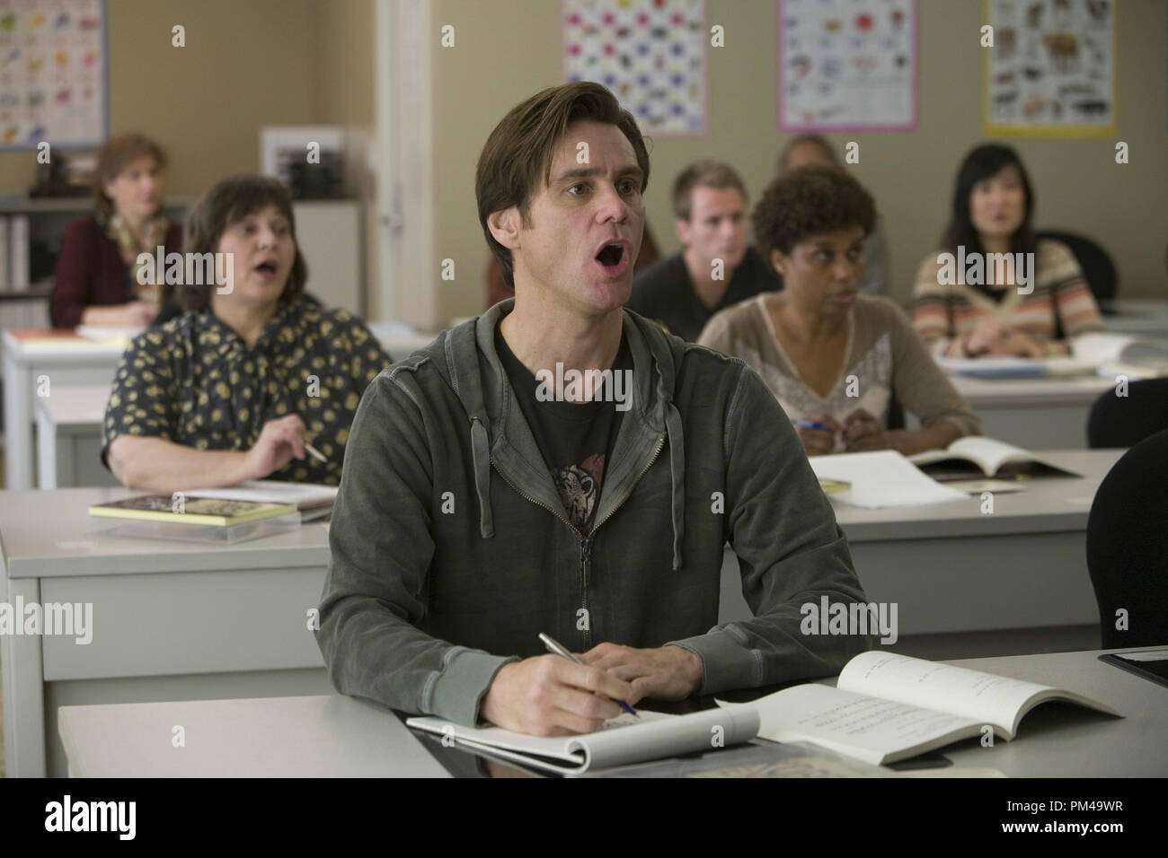 Carl (JIM CARREY) takes notes as he learns Korean in Warner Bros. Pictures' and Village Roadshow's comedy 'Yes Man,' distributed by Warner Bros. Pictures. Stock Photo