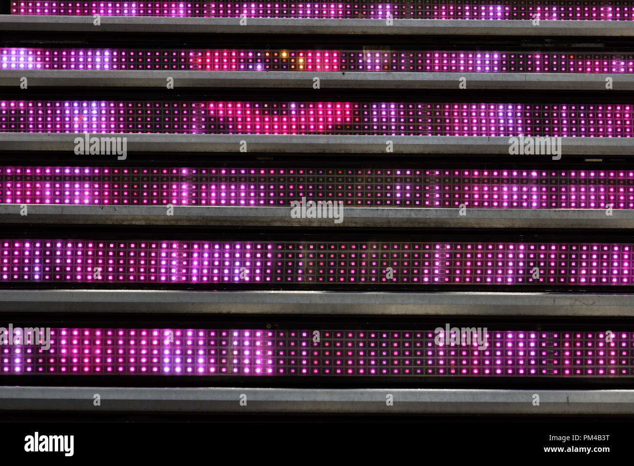 Abstract Image Showing Multiple Rows Of Led Lights Between Stairs Stock Photo