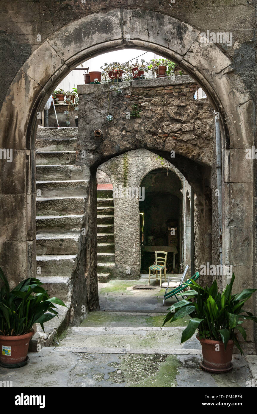 Entrance arch to ancient courtyards, access stairways to the houses in the medieval town of Castiglione a Casauria.Province of Pescara, Abruzzo, Italy Stock Photo