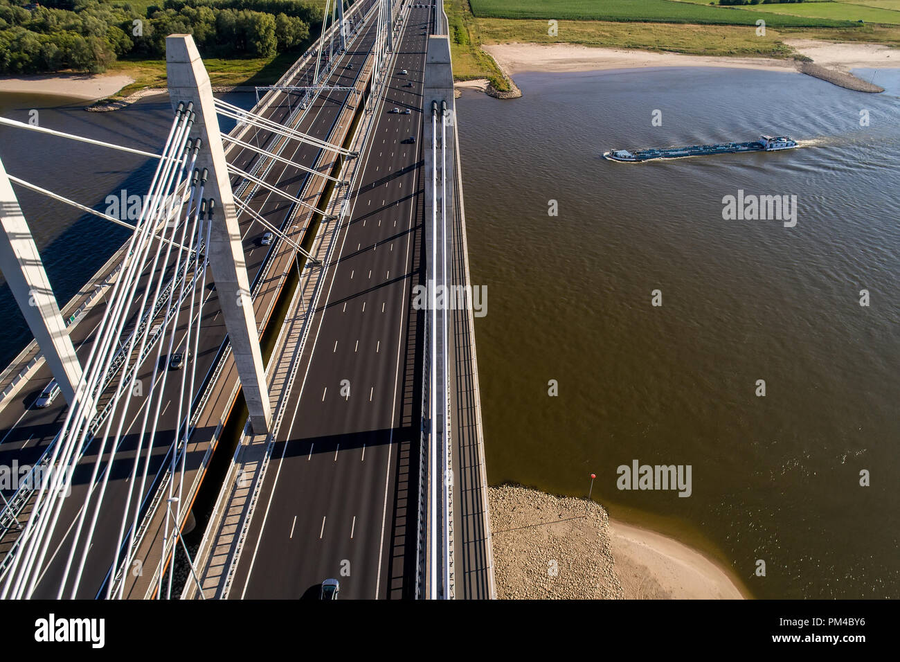 Aerial view of the bridge and the road with cars over the river Rhine in an area of the Netherlands Stock Photo