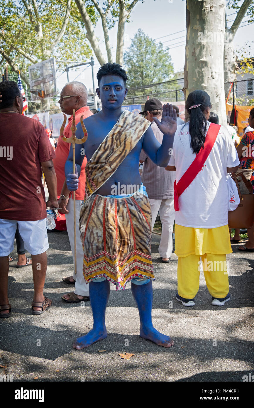 Posed portrait of a Hindu young man in blue dressed as the God Shiva at the conclusion of the Madrassi Parade in Richmond Hill, Queens, New York. Stock Photo
