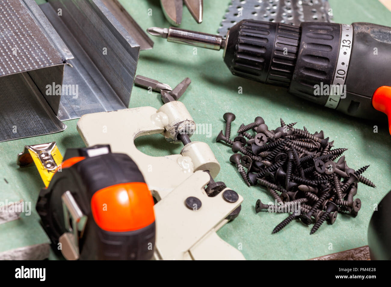 Plasterboard tools set with metal studs, screws, tape measure, screwgun