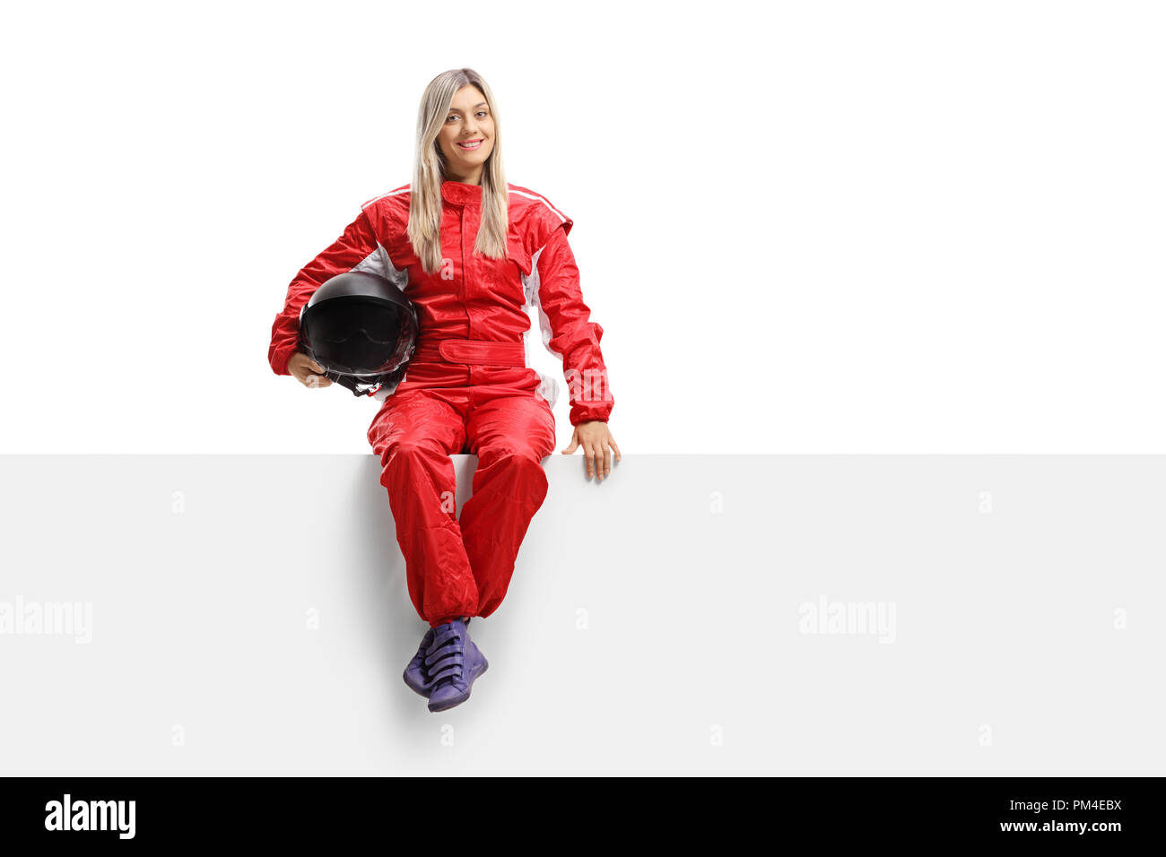 Female racer in a suit sitting on a panel isolated on white background Stock Photo