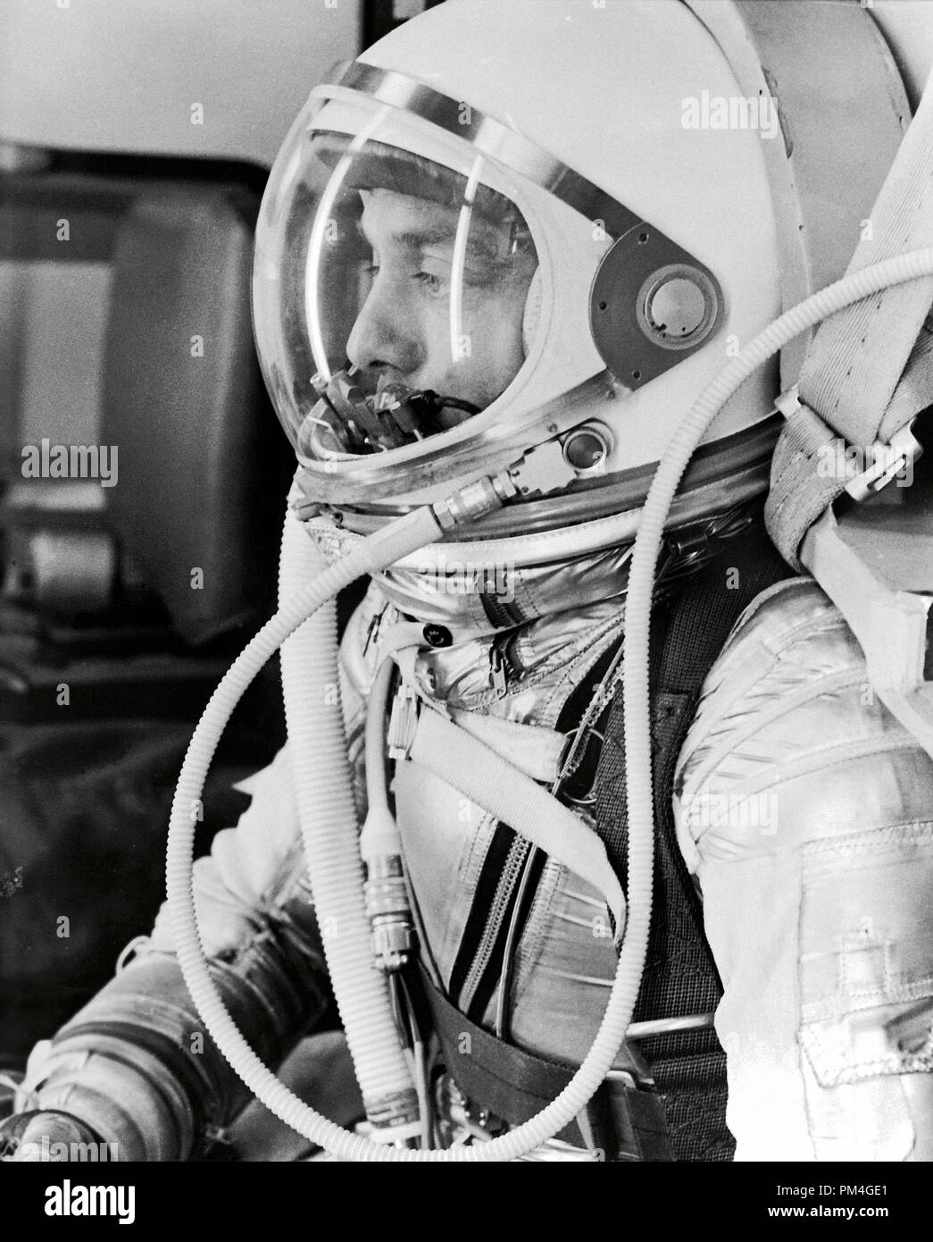 Profile of astronaut Alan Shepard in his silver pressure suit with the helmet visor closed as he prepares for his upcoming Mercury-Redstone 3 (MR-3) launch. On May 5th 1961, Alan B. Shepard Jr. became the first American to fly into space. His Freedom 7 Mercury capsule flew a suborbital trajectory lasting 15 minutes 22 seconds. His spacecraft splashed down in the Atlantic Ocean where he and Freedom 7 were recovered by helicopter and transported to the awaiting aircraft carrier U.S.S. Lake Champlain.    File Reference # 1001 008THA Stock Photo