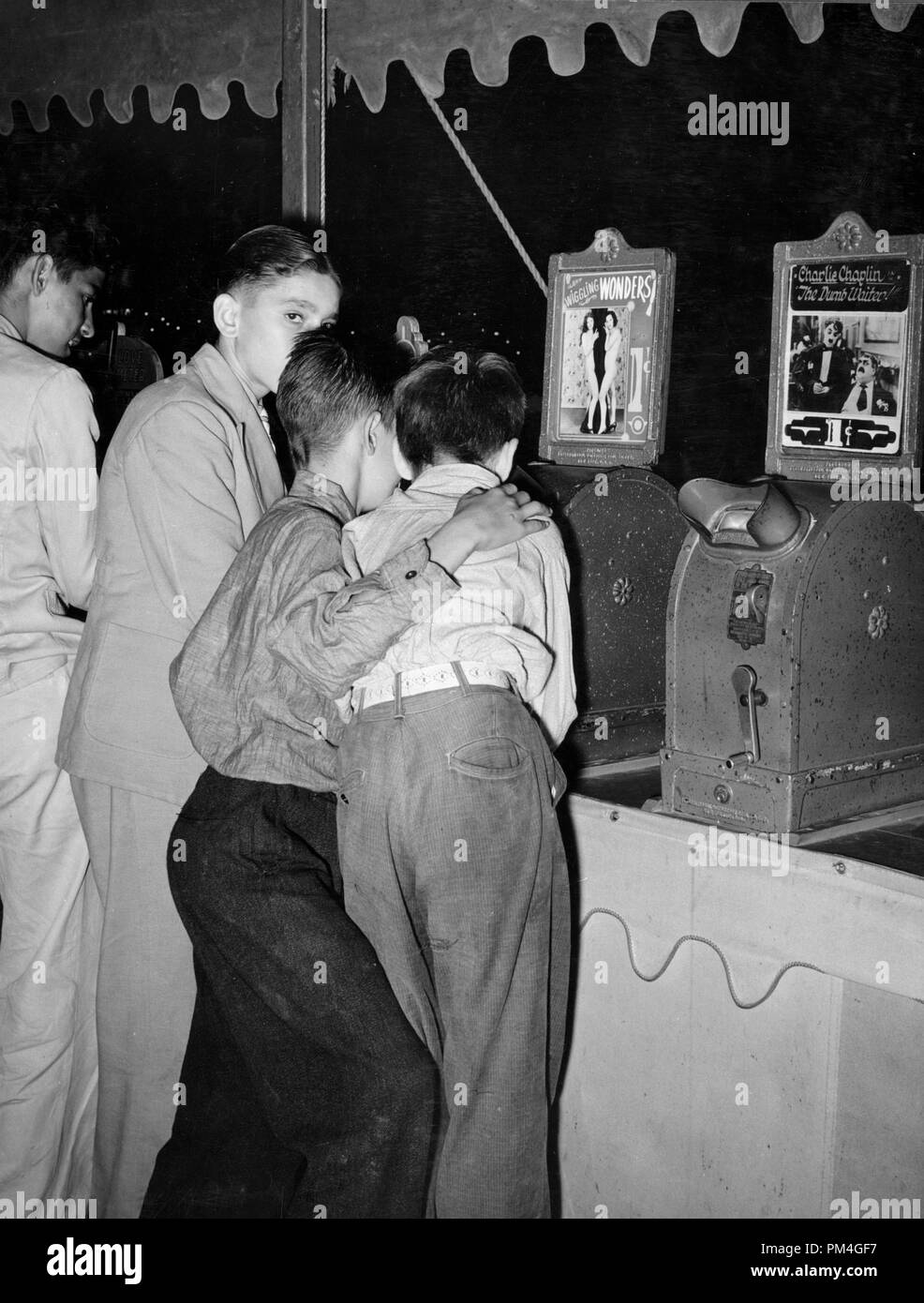 Boys looking at penny movies at South Louisiana State Fair. Donaldsonville, Louisiana, 1938.  File Reference # 1002 014THA Stock Photo