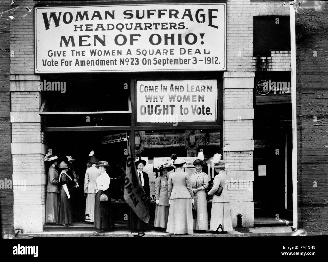 Woman suffrage headquarters in Upper Euclid Avenue, Cleveland--A. (at extreme right) is Miss  Belle Sherwin, President, National League of Women Voters; B. is Judge Florence E. Allen  (holding the flag); C. is Mrs. Malcolm McBride, 1912.  File Reference # 1003 023THA Stock Photo