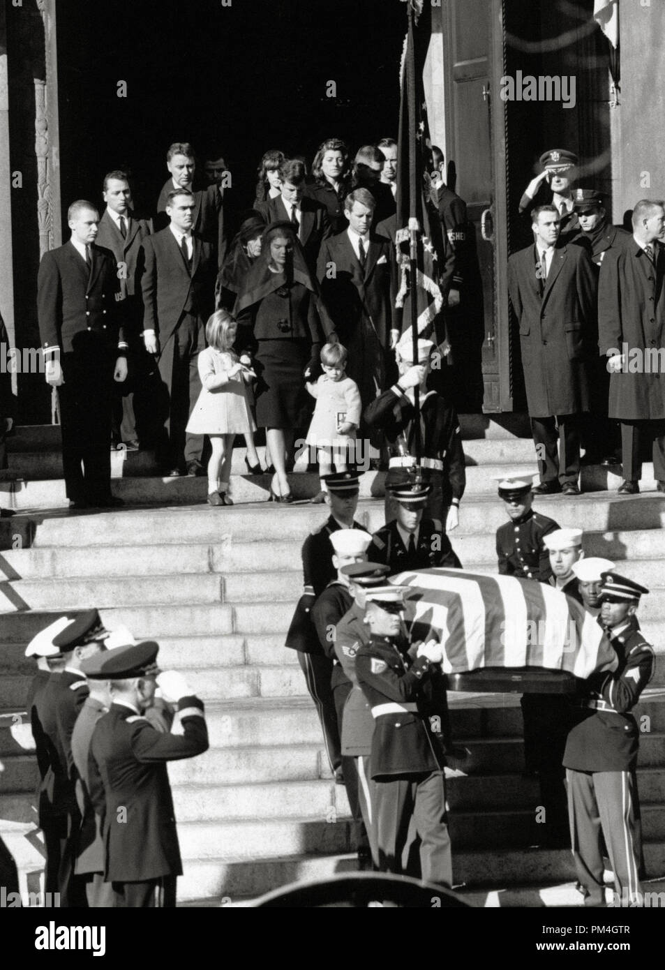 The coffin of assassinated American President John F. Kennedy is carried down the steps at St Matthew's Cathedral, Washington, after the requiem mass. Following the coffin is his widow Jacqueline Bouvier Kennedy, their children Caroline and John Jr. and Robert Kennedy. (Photo NARA)   File Reference # 1003 112THA Stock Photo