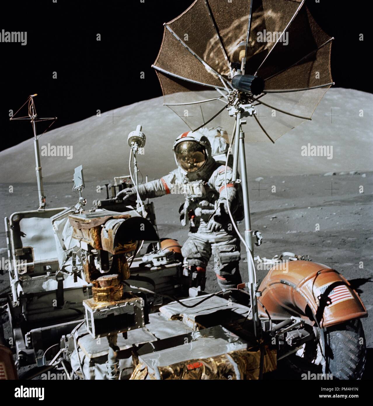 (13 Dec. 1972) --- Astronaut Eugene A. Cernan, Apollo 17 commander, approaches the parked Lunar Roving Vehicle (LRV) on the lunar surface during the flight's third period of extravehicular activity (EVA). South Massif can be seen in the background. The photograph was taken with a hand-held Hasselblad camera by scientist-astronaut Harrison H. Schmitt, lunar module pilot. While the two explored the surface of the moon, astronaut Ronald E. Evans remained with the Command and Service Modules (CSM) in lunar orbit.   File Reference # 1003 179THA Stock Photo