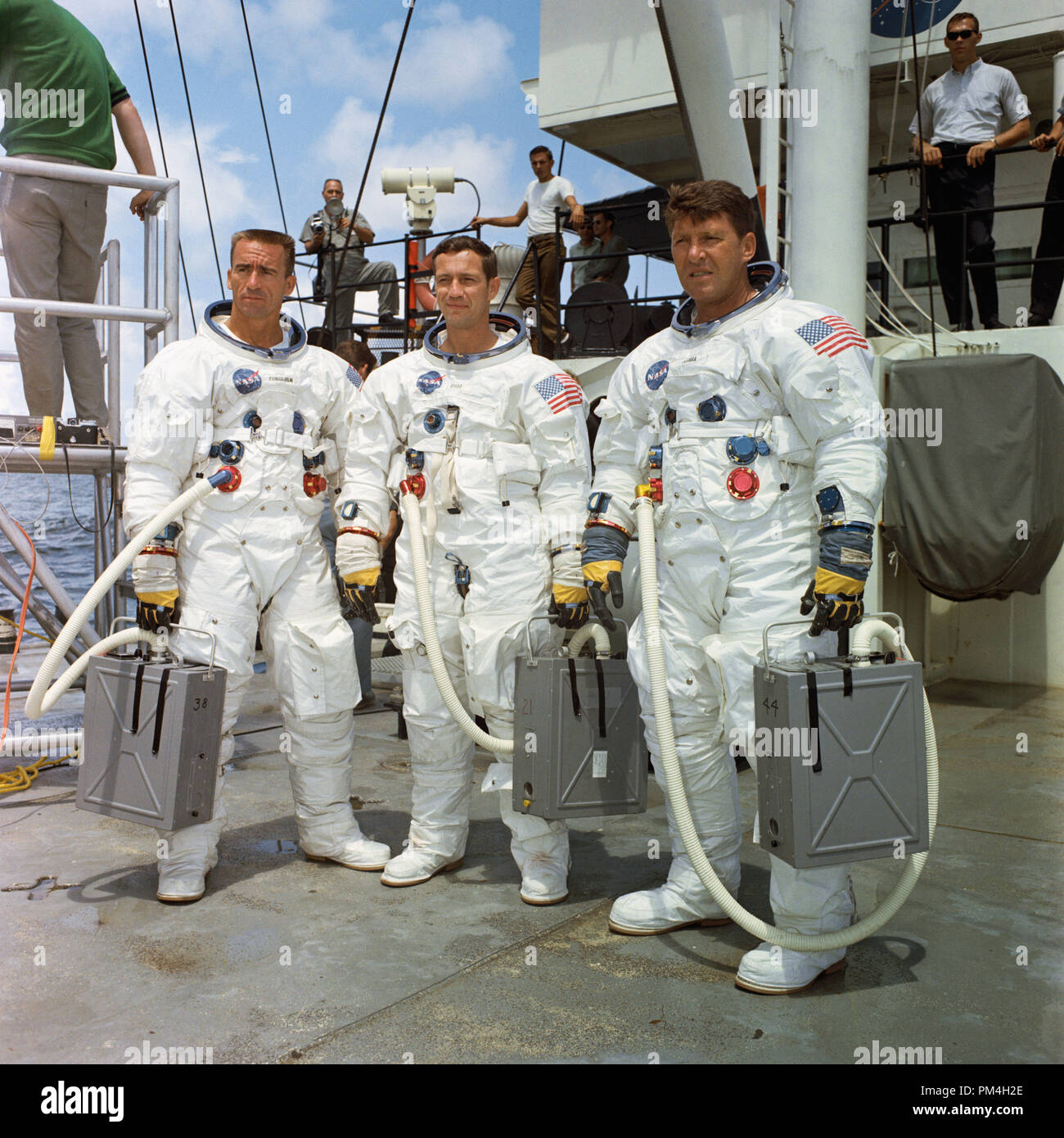 The prime crew of the first manned Apollo space mission, Apollo 7, stands on the deck of the NASA Motor Vessel Retriever after suiting up for water egress training in the Gulf of Mexico. Left to right, are astronauts Walter Cunningham, Donn F. Eisele, and Walter M. Schirra Jr. (1968)   File Reference # 1003 192THA Stock Photo