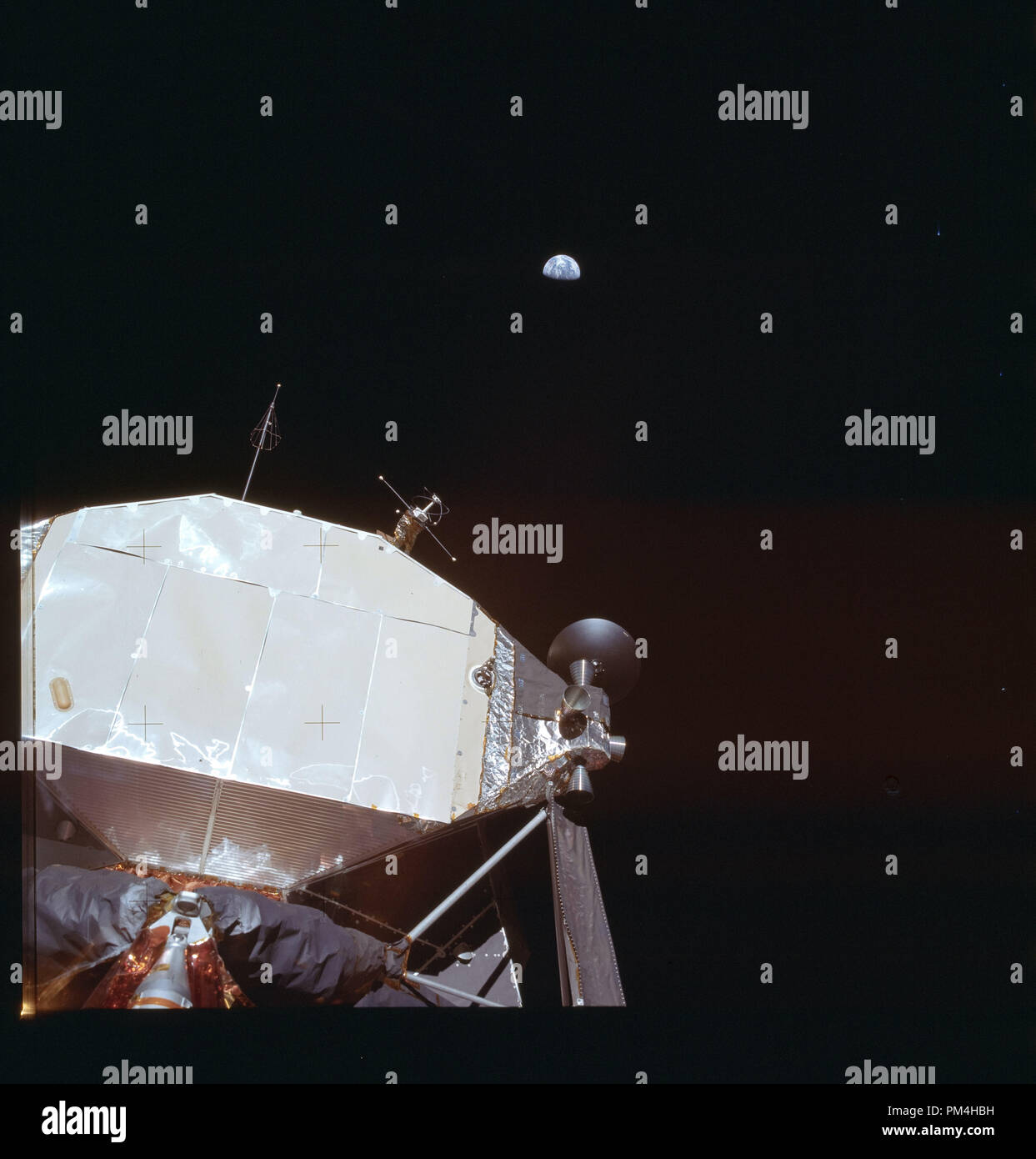 Apollo 11 lunar landing module on the moon during July 20, 1969's  history making voyage to the moon, view of Earth in the distance.  File Reference # 1003 281THA Stock Photo