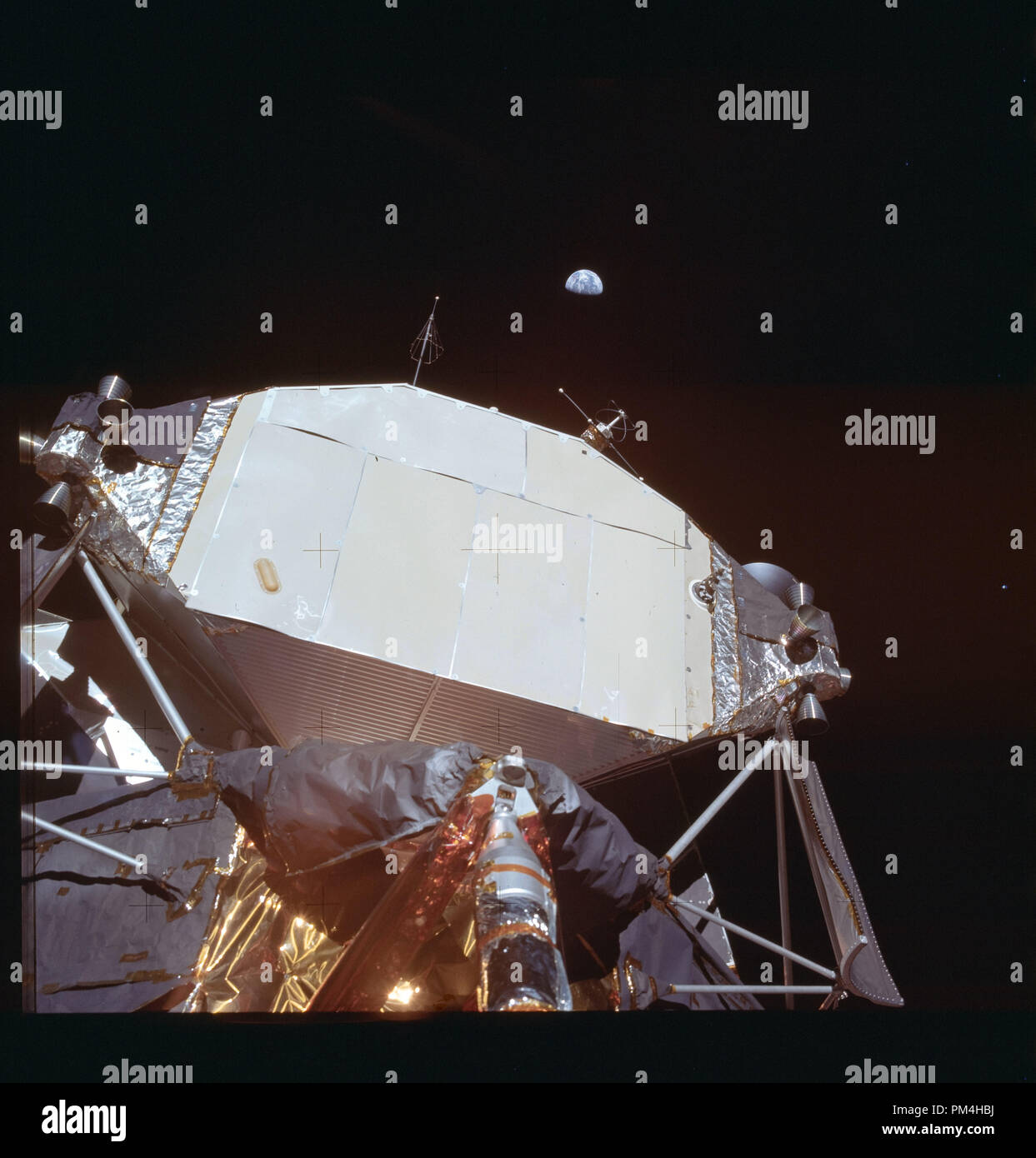 Apollo 11 lunar landing module on the moon during July 20, 1969's  history making voyage to the moon, view of Earth in the distance.  File Reference # 1003 282THA Stock Photo