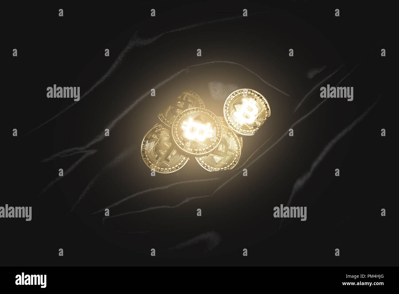 Golden shiny bitcoin lies on the dark material. Stock Photo