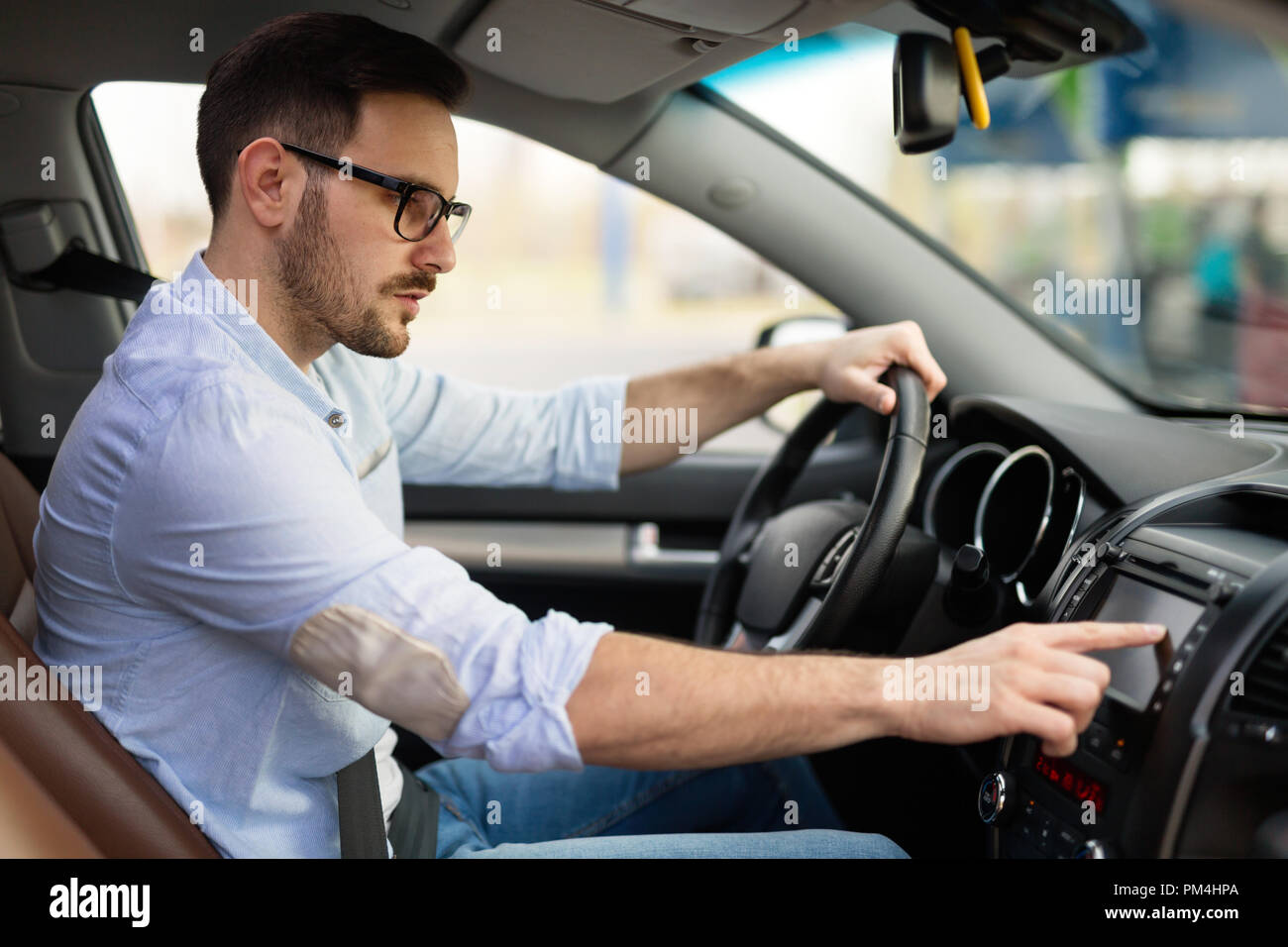 Man using navigation system while driving car Stock Photo