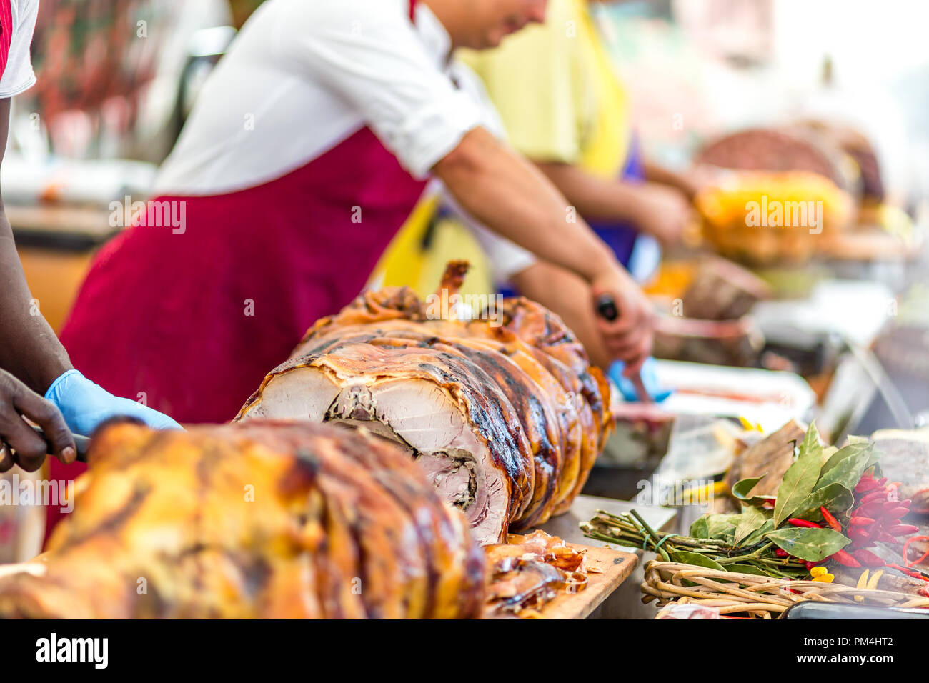 butchers slicing roasted pork in Italian stand Stock Photo Alamy