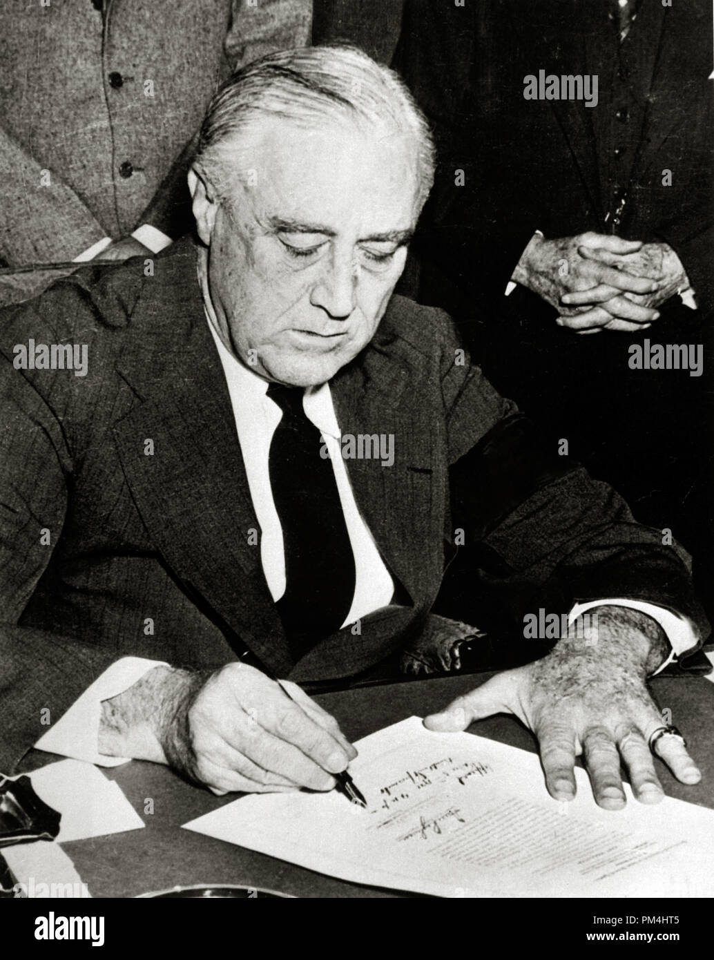 President Franklin Delano Roosevelt signing declaration of war against Japan December 8, 1941  File Reference # 1003 405THA Stock Photo