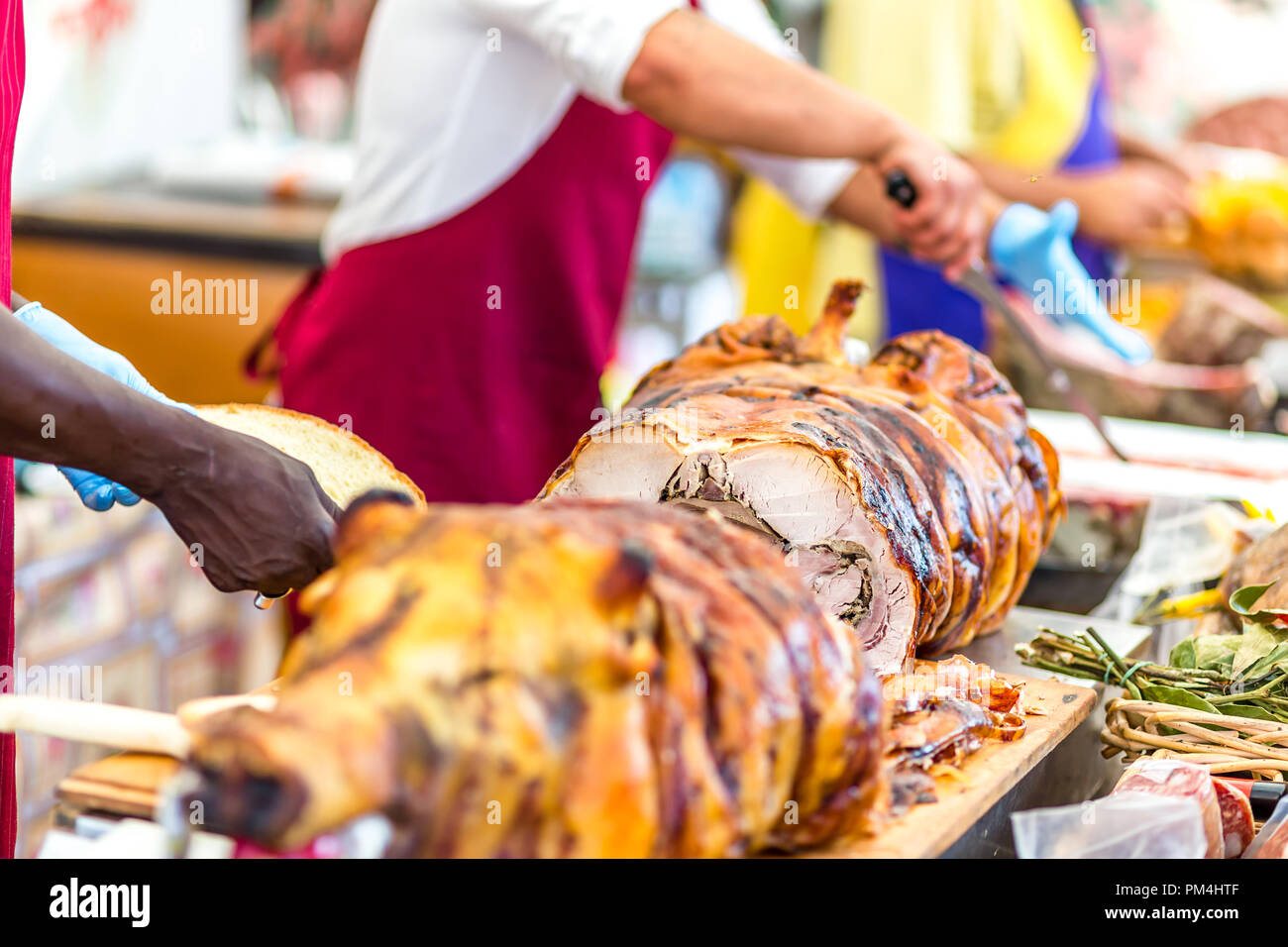 butchers slicing roasted pork in Italian stand Stock Photo Alamy