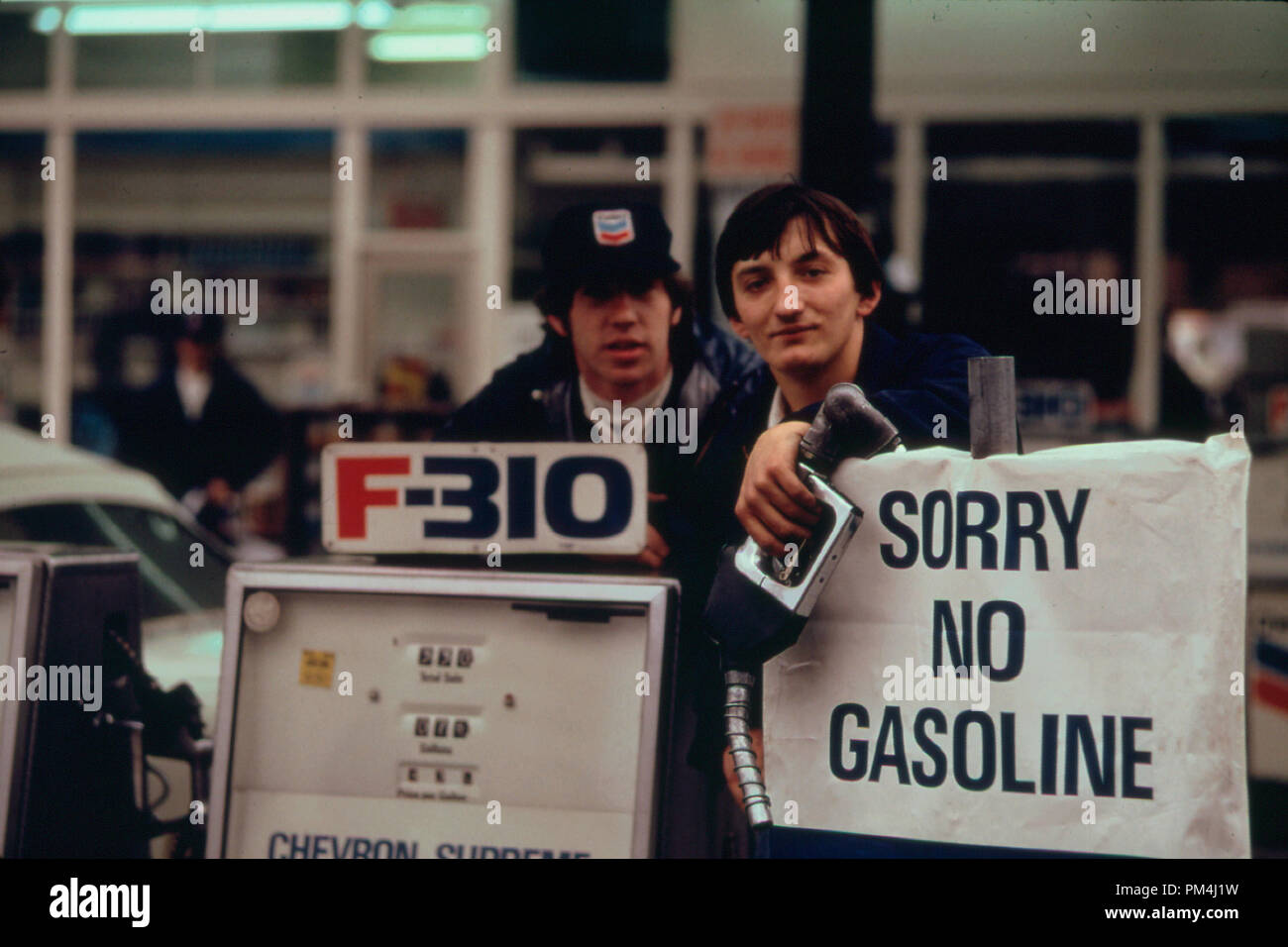 Gas Station Attendants Peer over Their 'Out of Gas' Sign in Portland, Oregon  on Day before the State's Requested Saturday Closure of Gasoline Stations 11/1973   File Reference # 1003 476THA Stock Photo