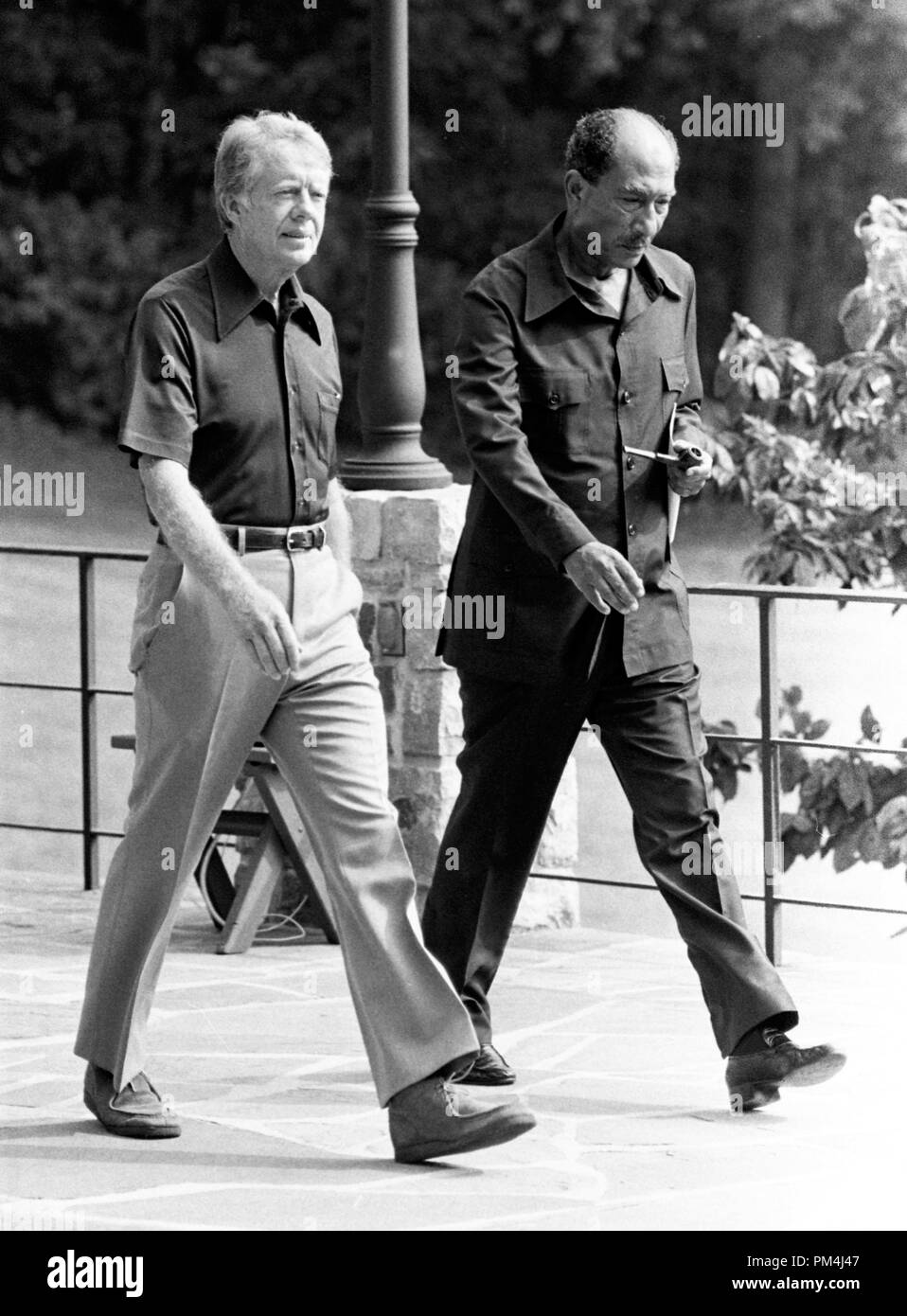 United States President Jimmy Carter, left and President Anwar Sadat of Egypt, right, walk behind Aspen Lodge at Camp David, near Thurmont, Maryland prior to their meeting on Tuesday, September 12, 1978. Photo by White House   File Reference # 1003 508THA Stock Photo