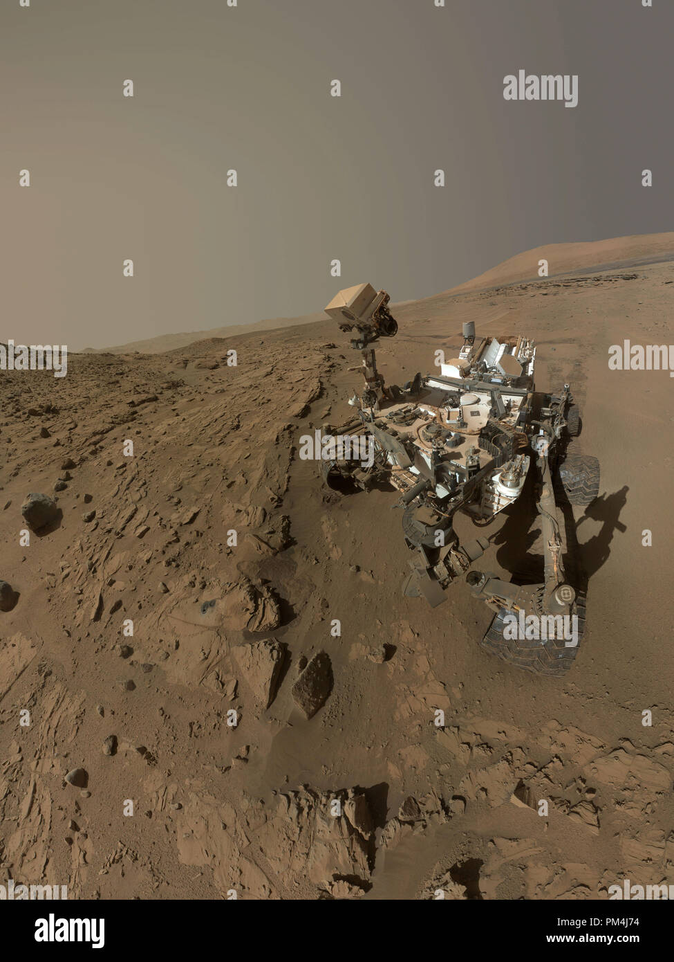 NASA's Curiosity Mars rover used the camera at the end of its arm in April and May 2014 to take dozens of component images combined into this self-portrait where the rover drilled into a sandstone target called 'Windjana.' The camera is the Mars Hand Lens Imager (MAHLI), which previously recorded portraits of Curiosity at two other important sites during the mission: 'Rock Nest' and 'John Klein'.  File Reference # 1003 576THA Stock Photo