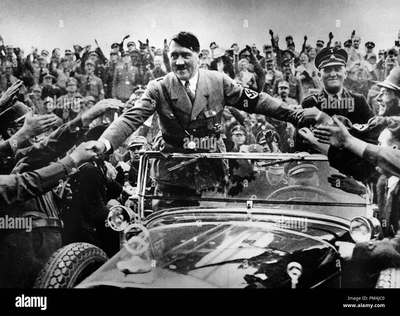 Adolf Hitler, Chancellor of Germany, is welcomed by supporters at Nuremberg, circa 1933   File Reference # 1003 661THA Stock Photo