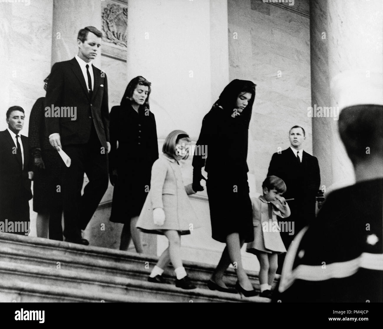 President's Family leaves Capitol after Ceremony. Caroline Kennedy, Jacqueline Bouvier Kennedy, John F. Kennedy, Jr. (2nd row) Attorney General Robert F. Kennedy, Patricia Kennedy Lawford (hidden) Jean Kennedy Smith (3rd Row) Peter Lawford. United States Capitol, East Front, Washington, D.C. November 25, 1963    File Reference # 1003 669THA Stock Photo