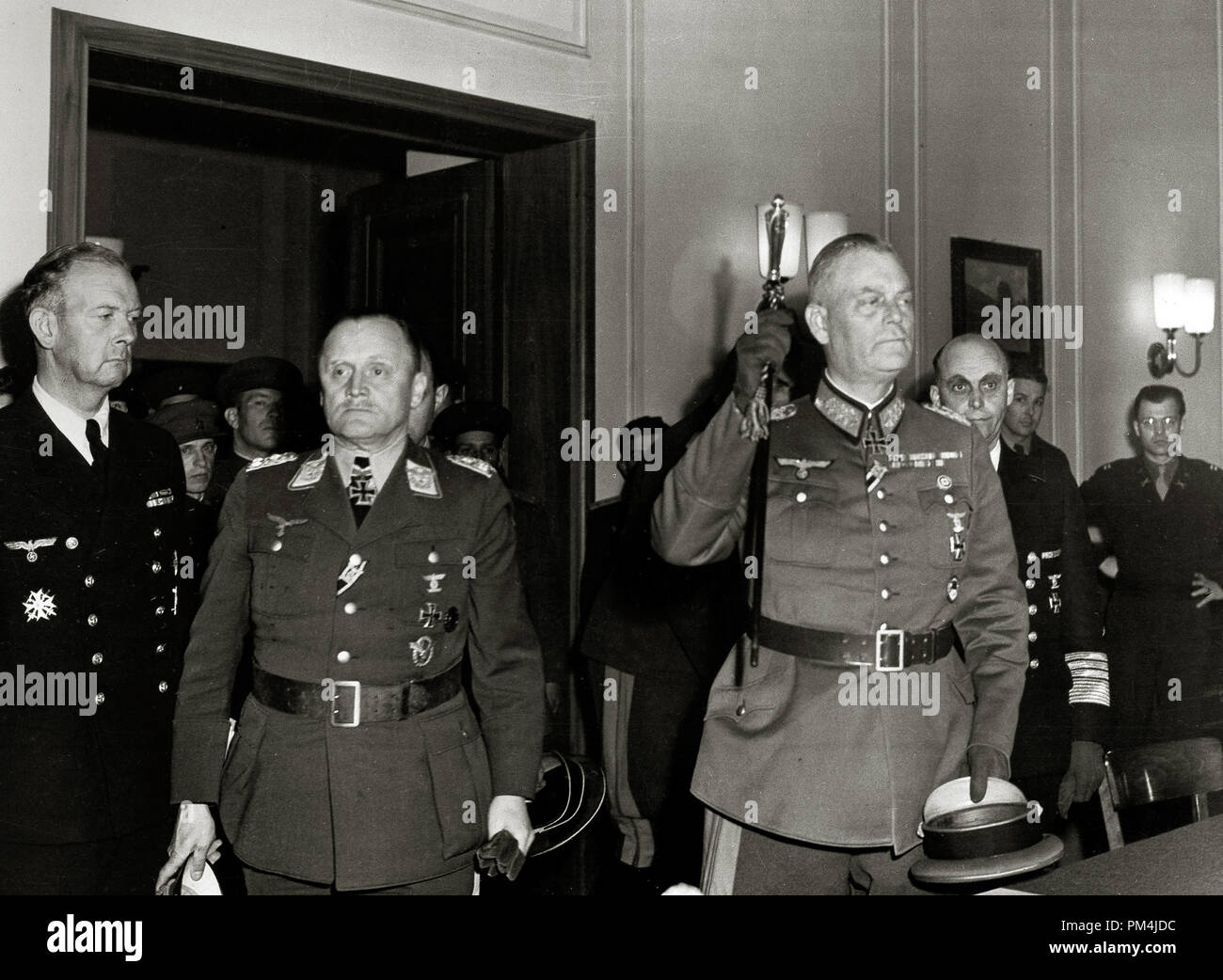 Colonel-General Paul Stumpff, second left, Luftwaffe commander; Field Marshal Wilhelm Keitel, German army commander, raising baton; and General Admiral Hans von Freideburg, rear, commander of the German navy; emerge after Germany's unconditional surrender was formally ratified in Berlin, May 9, 1945   File Reference # 1003 679THA Stock Photo