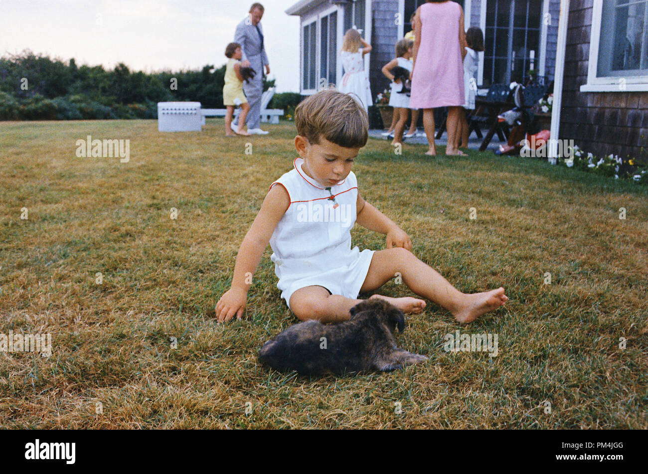 John F. Kennedy Jr. with puppy. Hyannisport, MA, Squaw Island August 3, 1963. Photo by Cecil Stoughton / NARA   File Reference # 1003 752THA Stock Photo