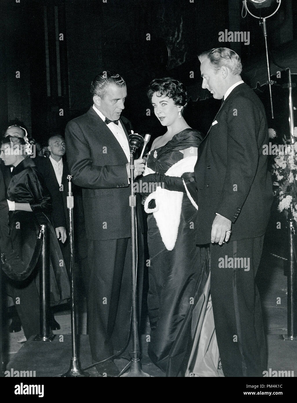 Elizabeth Taylor and Michael Wilding being interviewed by Ed Sullivan at a formal event, circa 1952. File Reference #1014 013 THA © JRC /The Hollywood Archive - All Rights Reserved. Stock Photo