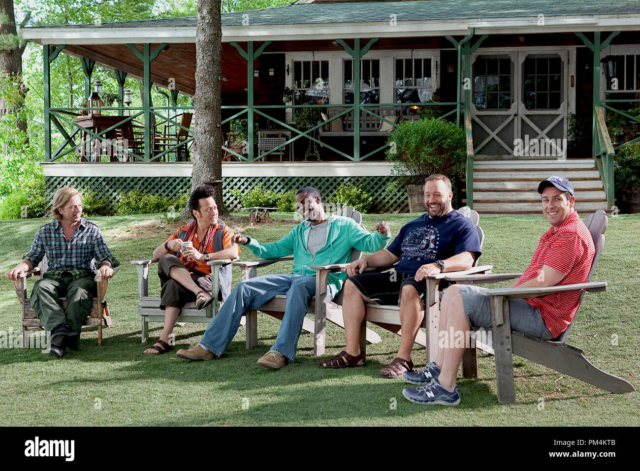 Friends and former teammates sit in their Adirondack chairs on the lawn in front of the house overlooking the lake while catching up.  Marcus Higgins (David Spade), Rob Hilliard (Rob Schneider), Kurt McKenzie (Chris Rock), Eric Lamonsoff (Kevin James), and Lenny Feder (Adam Sandler). Stock Photo