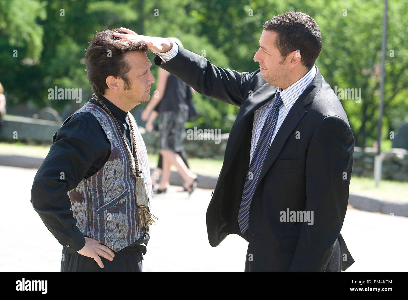 Lenny Feder (Adam Sandler) greets old friend and teammate Rob Hilliard (Rob Schneider) in Columbia Pictures' GROWN UPS. Stock Photo