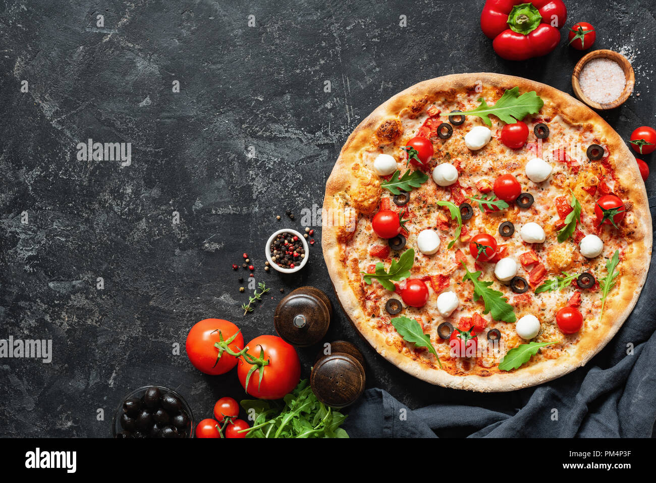 Italian Pizza On Black Concrete Background. Copy Space For Text. Tasty Pizza Stock Photo