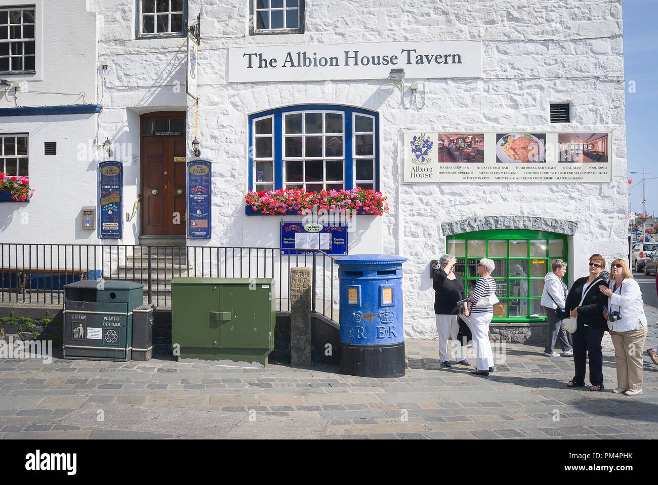 Outside The Albion House Tavern in St Peter Port Guernsey UK with a few local people and tourists to the island Stock Photo