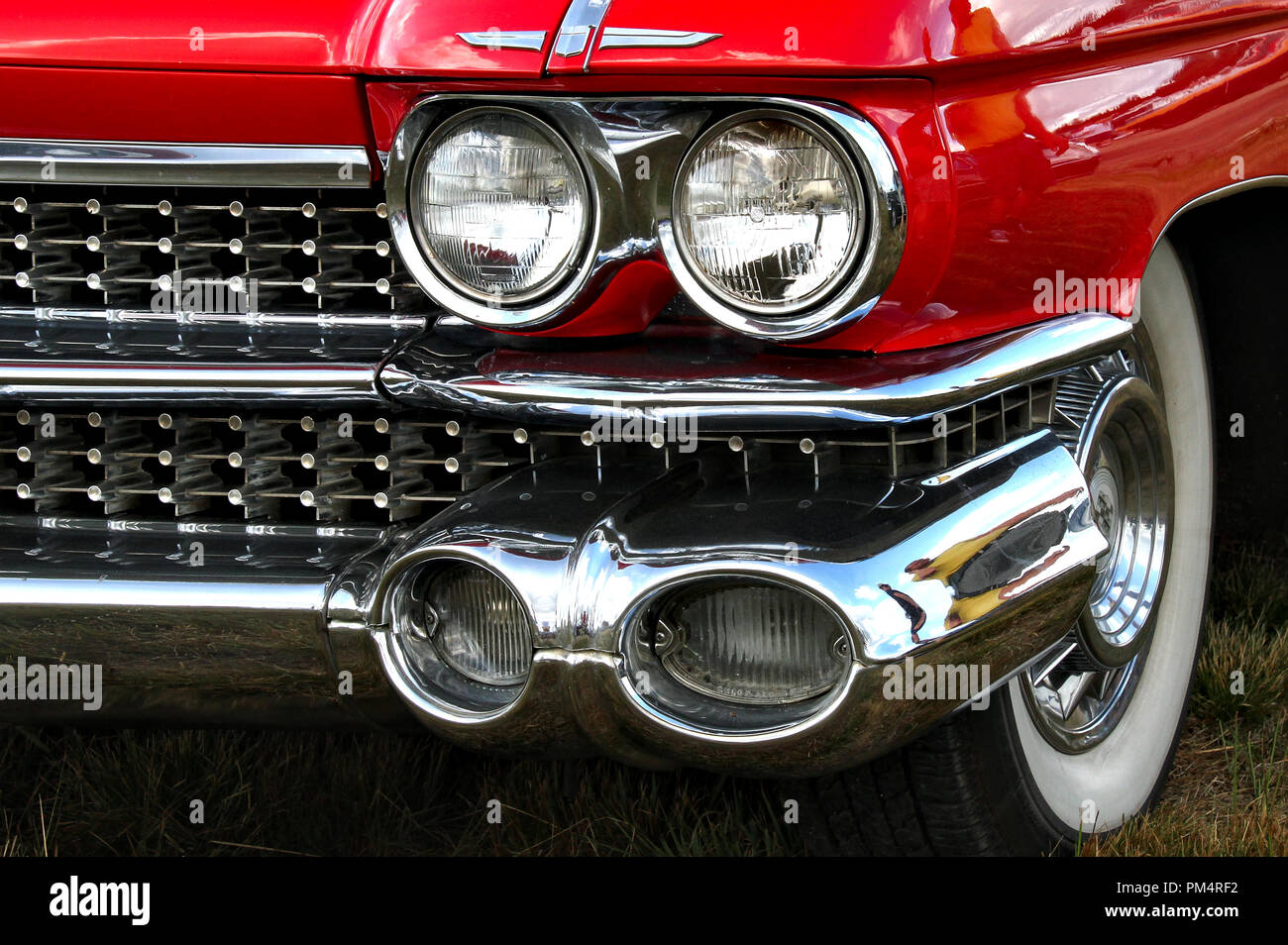 Two pairs of headlights and white wall tires of a shiny classic car Stock Photo