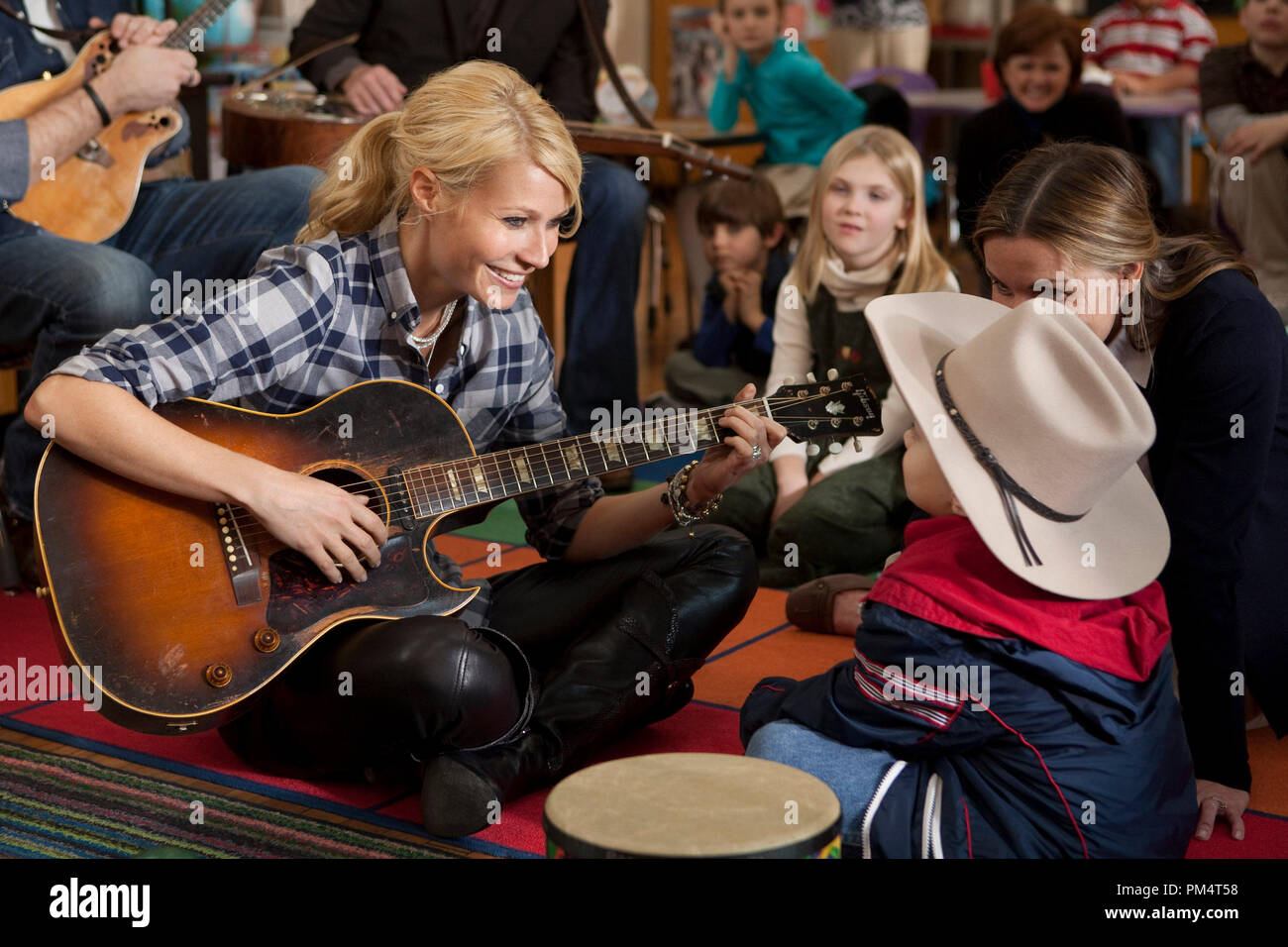 Kelly (Gwyneth Paltrow) readily agrees to sing for Travis (Gabe Sipos) as Travis's mom (Lisa Stewart Seals) sits beside him in Screen Gems' drama COUNTRY STRONG, 2010. Stock Photo