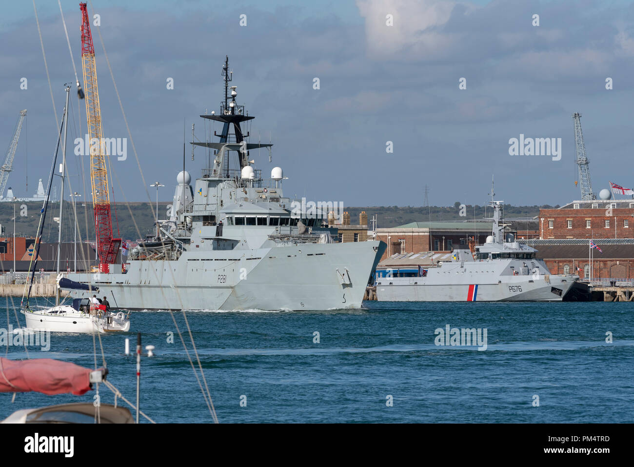 HMS Tyne departing Portsmouth to patrol the fisheries area, Passing the French navy vessel P676 Flamant. Stock Photo