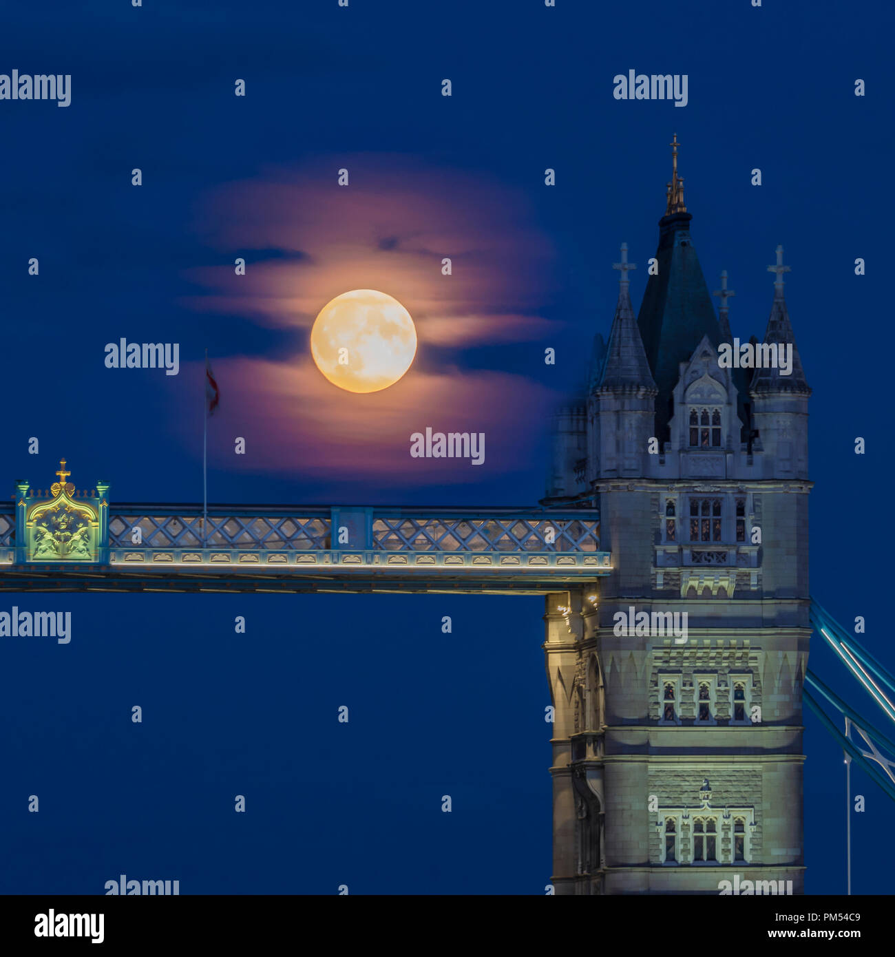 LONDON, UK - AUGUST 25, 2018:  A full moon rising over Tower Bridge in the City of London Stock Photo