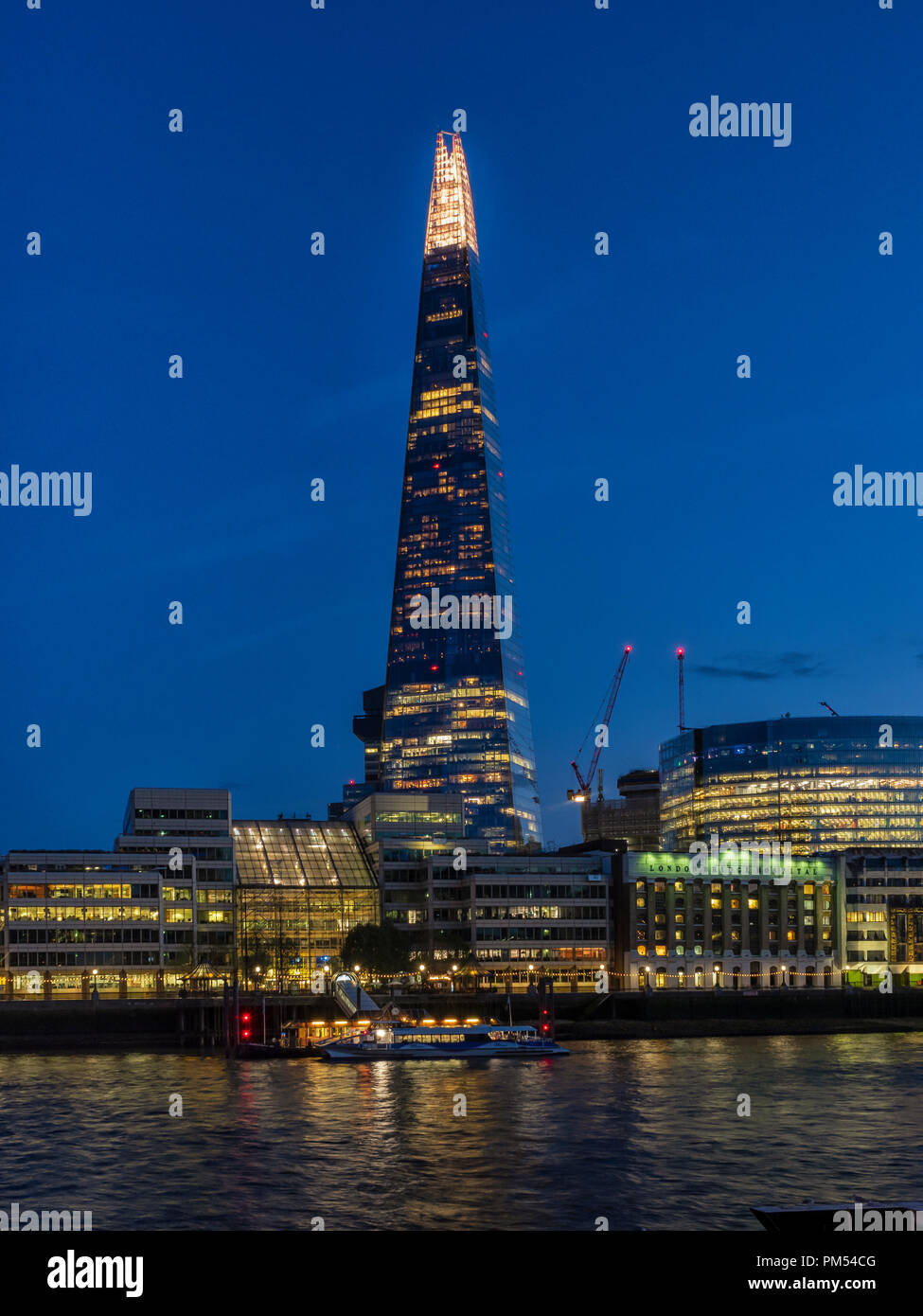 LONDON, UK - AUGUST 25, 2018:  View of the Shard building  Lit-Up at night seen across the River Thames Stock Photo