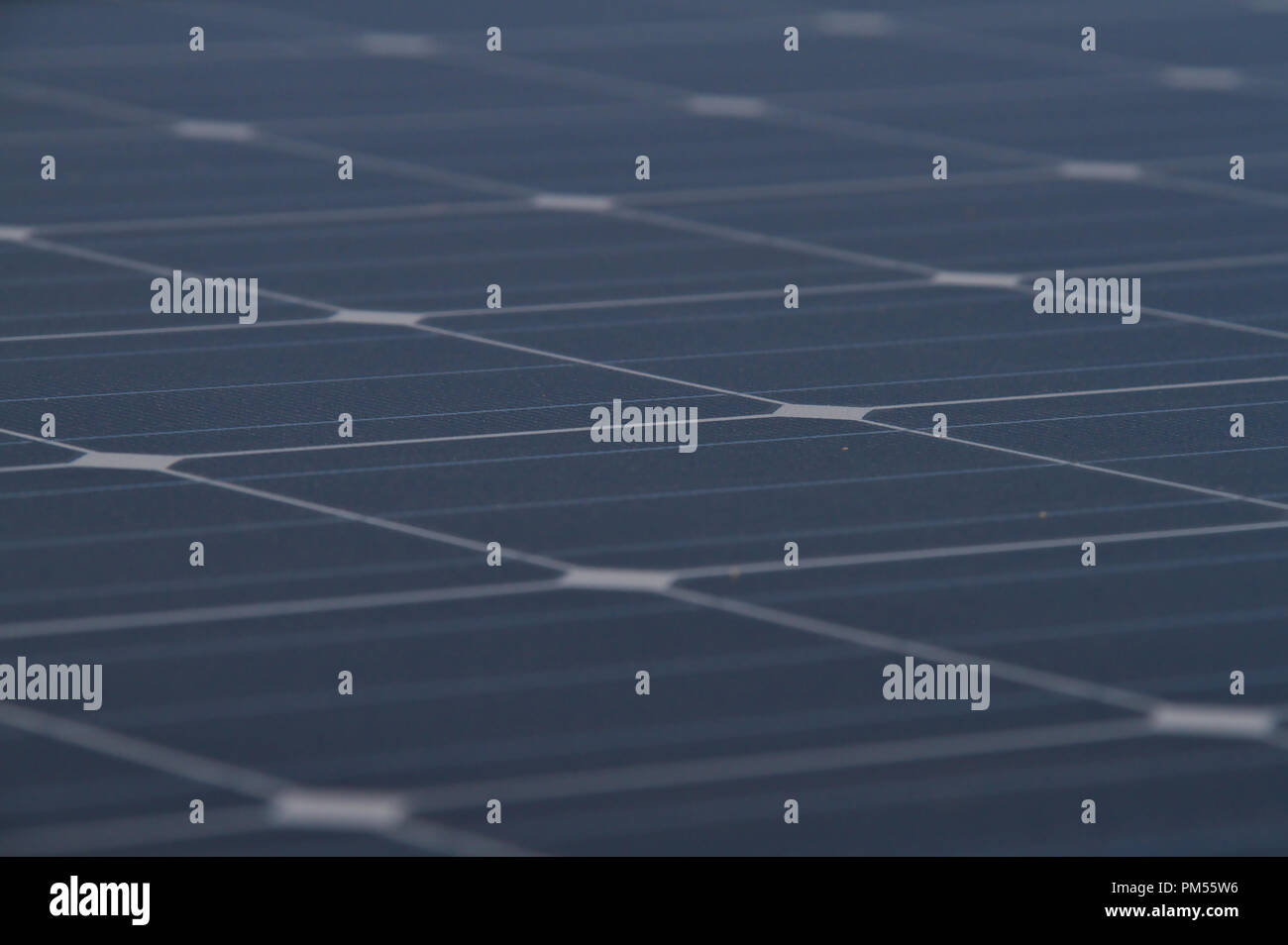 Low angle photo of the surface of a solar panel that produces electricity directly from the sunlight. Stock Photo