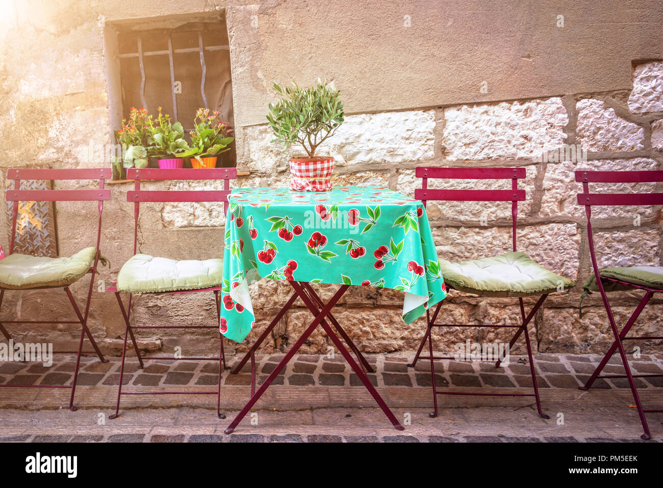 Cosy vintage cafe terrace in a street of Cassis on the French rivieria, France Stock Photo