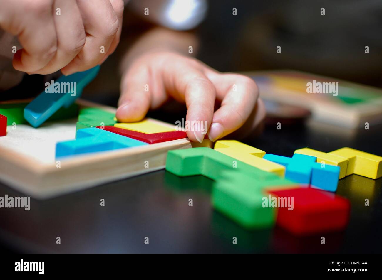 Colourful puzzle on black table makes great background. Stock Photo