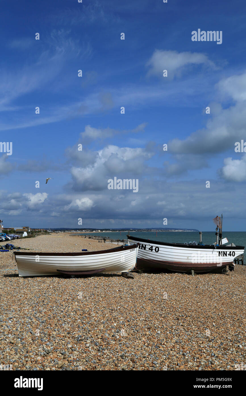 Fishing boats on shingle beach at Pevensey Bay, Pevensey, East Sussex