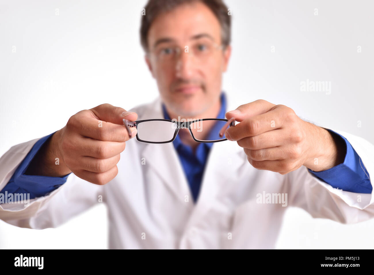 Doctor putting glasses on patient. Concept of visual correction with