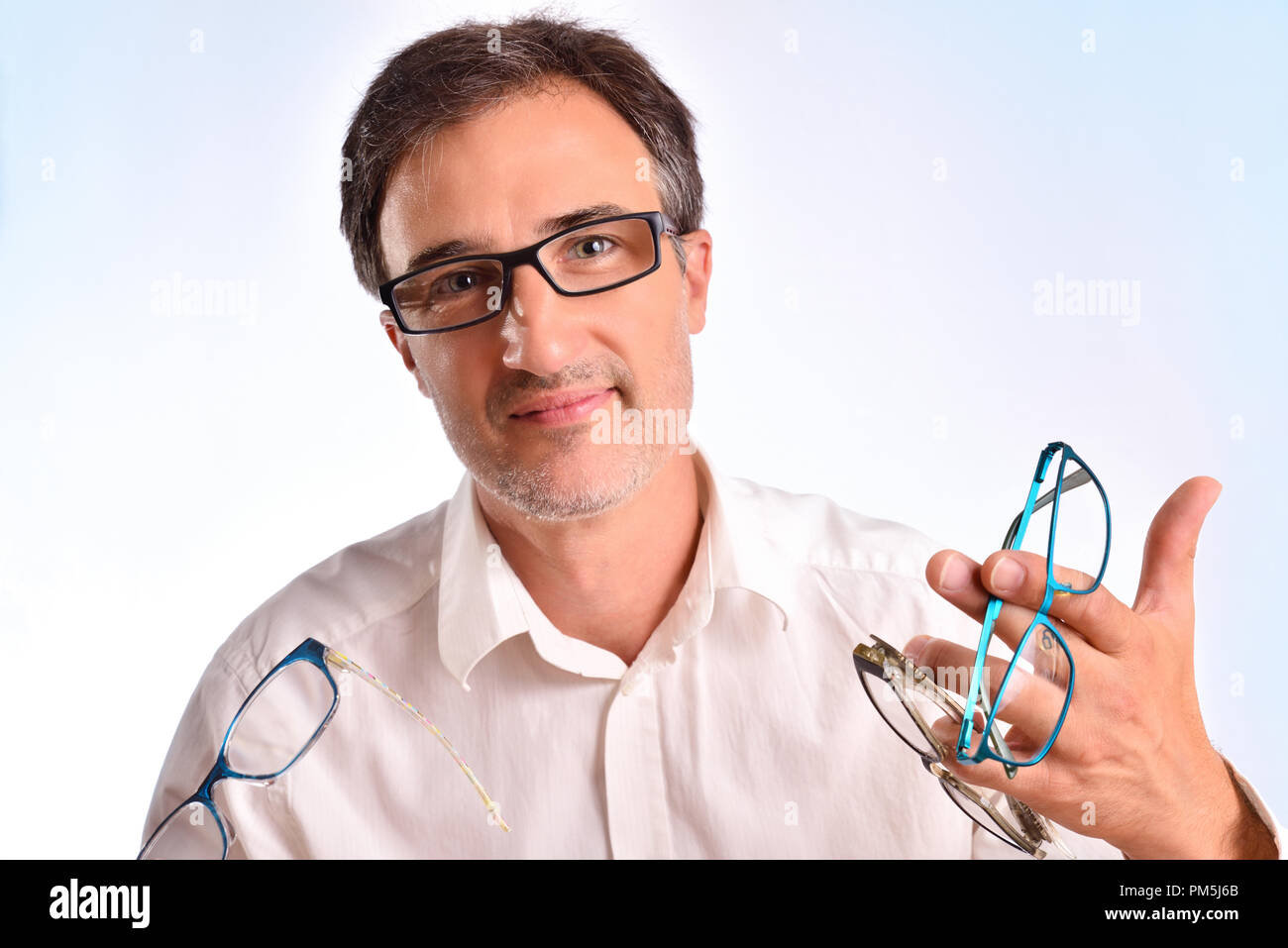 Optical business man showing several eyeglasses. Concept of visual