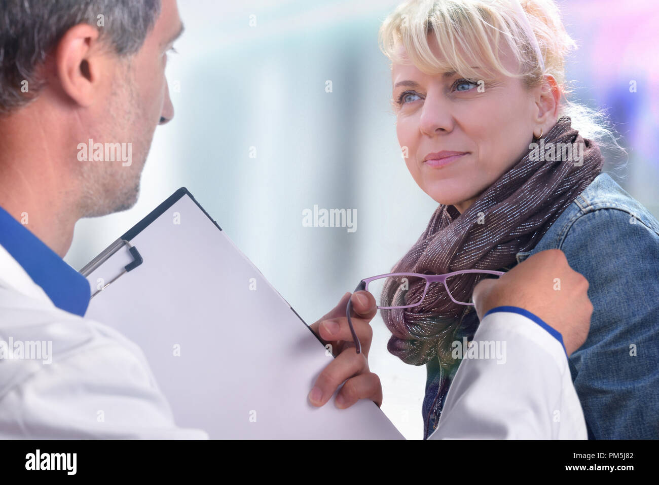 Optometrist showing a glasses to a woman. Horizontal composition. Stock Photo