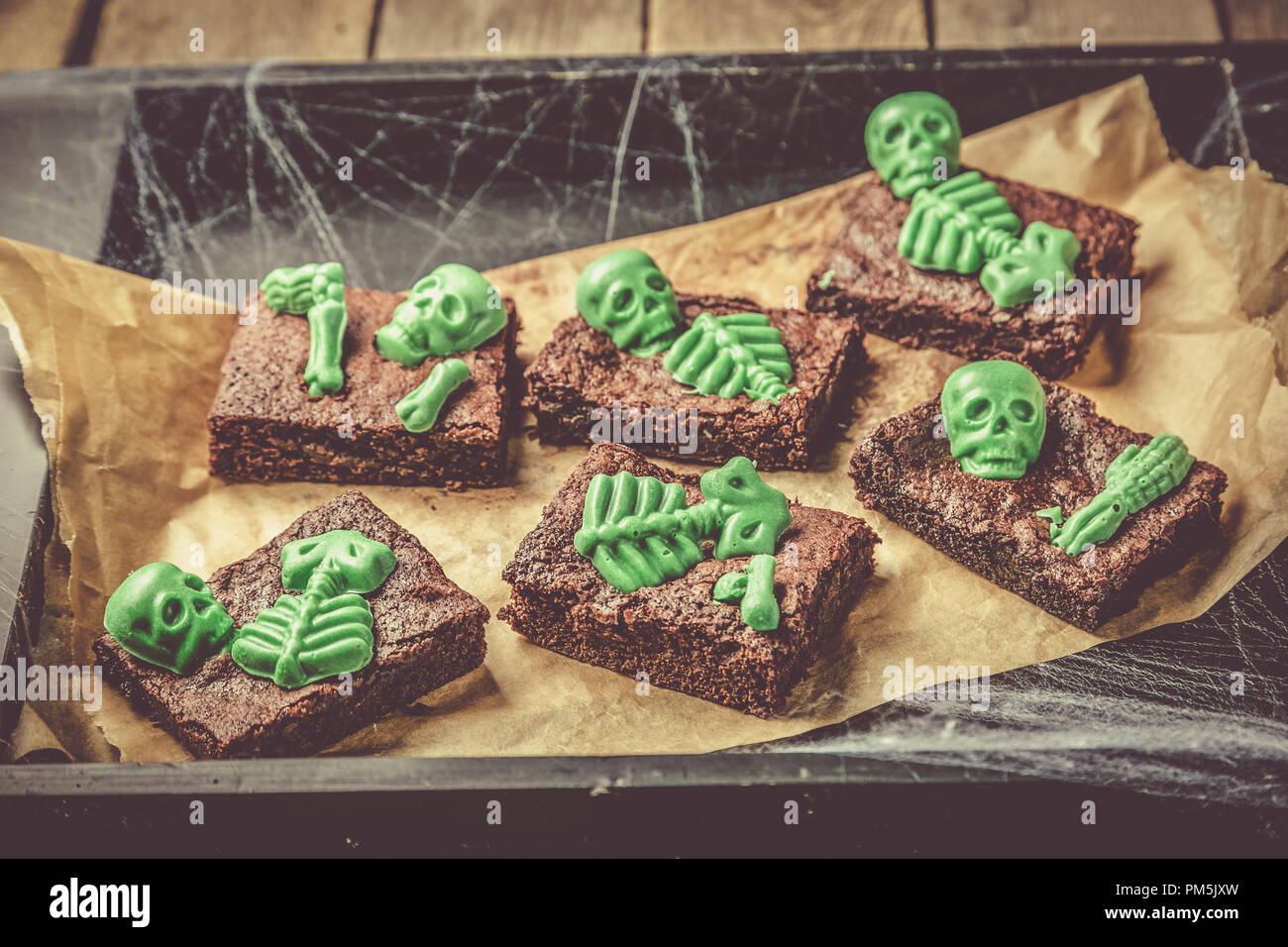 Halloween style party sweet brownie with green skeleton and bones