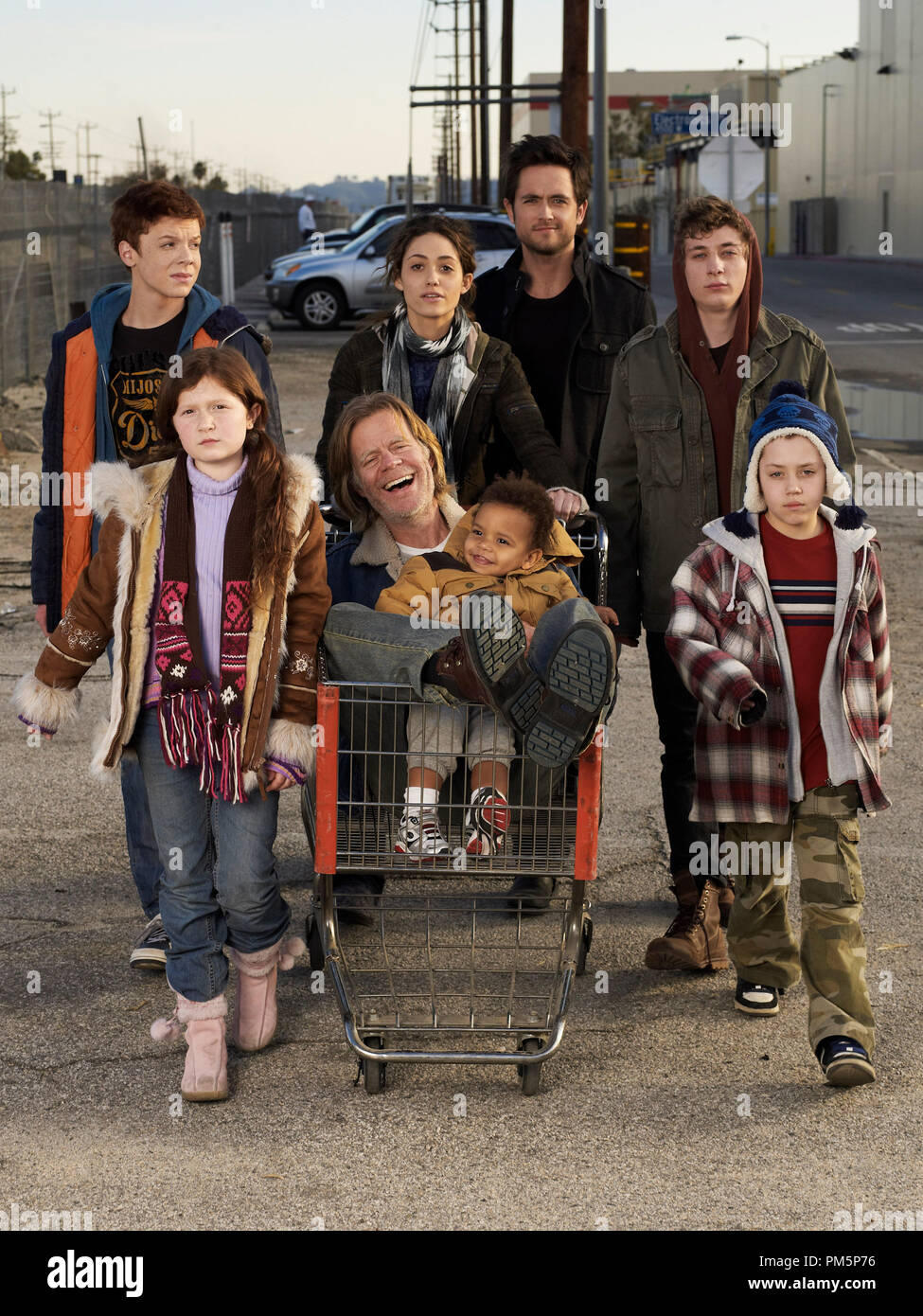 (From left to right) Cameron Monaghan as Ian, Emma Kenney as Debbie, William H. Macy as Frank, Blake and Brennan Johnson as Liam, Emmy Rossum as Fiona, Justin Chatwin as Steve, Jeremy White as Lip, and Ethan Cutkosky as Carl in Shameless - Photo: Gavin Bond/SHOWTIME Stock Photo