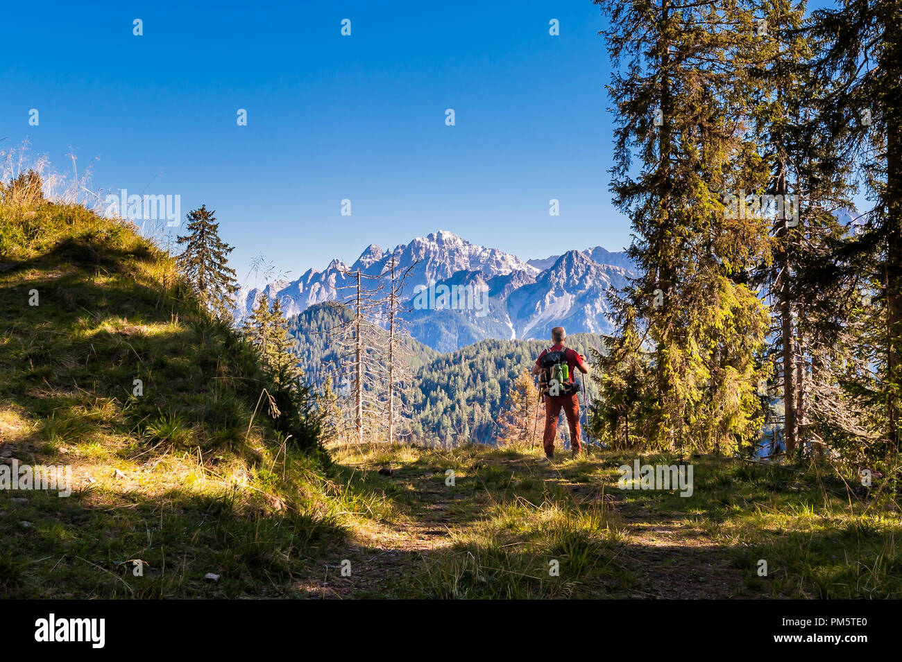 Hiker walking in the mountains. goal, success, freedom and achievement concept. Stock Photo