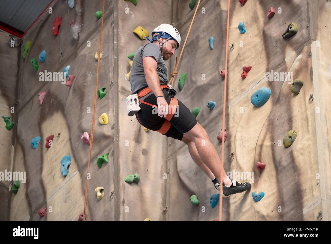 Man climber on artificial climbing wall Stock Photo Alamy