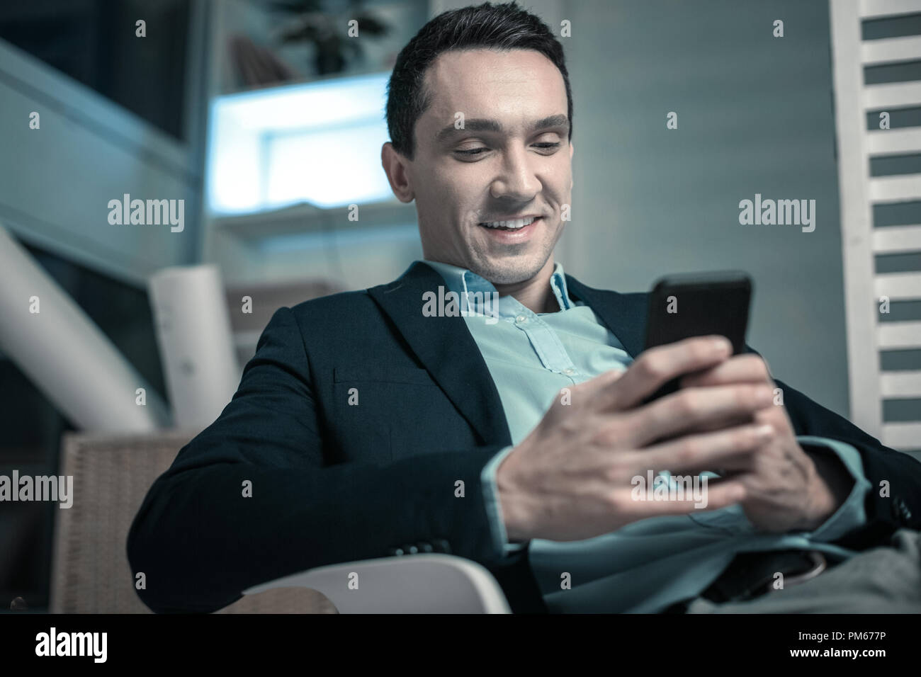 Handsome nice man holding a mobile phone Stock Photo